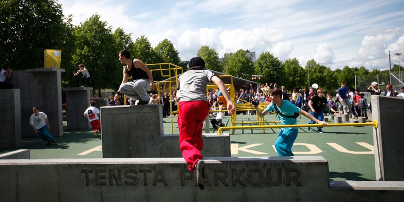 Tensta Parkour, in the northern suburb of Tensta is Stockholm’s first public parkour course. A sunny summer’s day. A group of young men practice parkour over the different obstacles in the park.