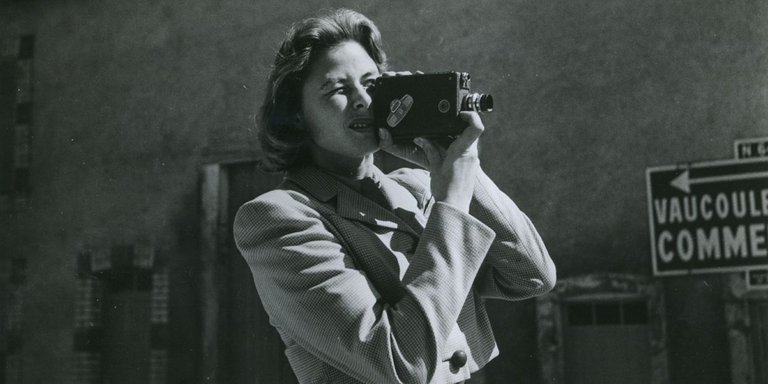 Black and white portrait of Ingrid Bergman holding an 8-millimeter camera. Born in Stockholm in 1915, Ingrid Bergman is considered one of the greatest movie stars of all time.